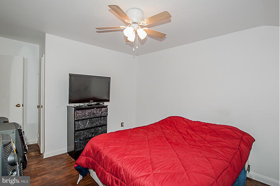 1072 Craftswood Road Baltimore, MD 21228 - Photo 10 of 18 a bedroom with a bed and a flat screen tv