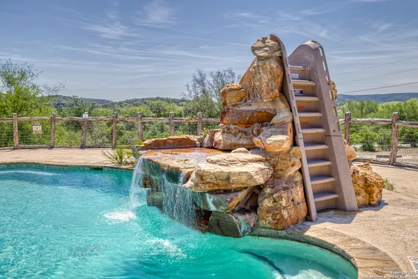 a view of a backyard with a garden and entertaining space
