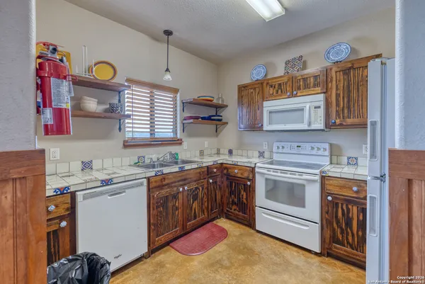a kitchen with a sink stove and cabinets