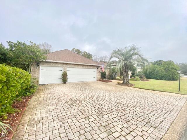 4401 Windrush Drive Niceville, FL 32578 - Photo 2 of 35 a front view of a house with a yard and garage