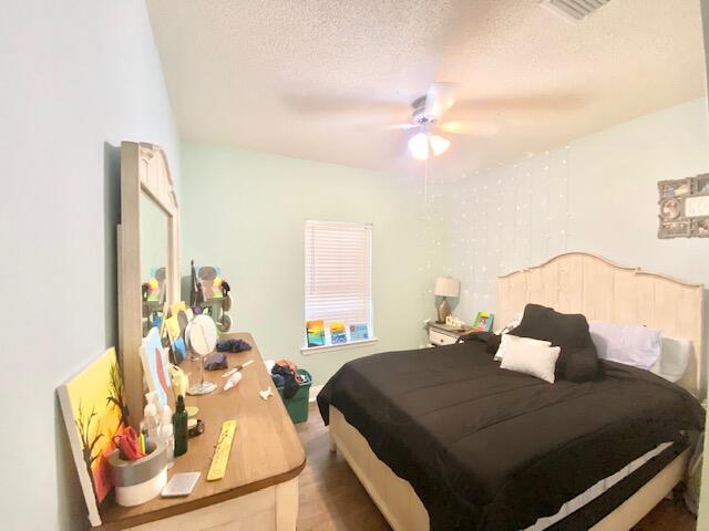 4401 Windrush Drive Niceville, FL 32578 - Photo 26 of 35 a bedroom with a bed and wooden floor