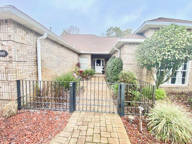 4401 Windrush Drive Niceville, FL 32578 - Photo 3 of 35 a front view of a house with a garden