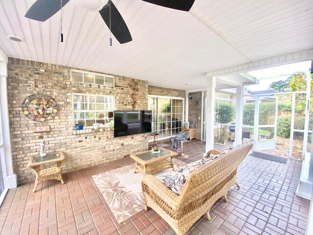 4401 Windrush Drive Niceville, FL 32578 - Photo 35 of 35 a living room with patio furniture and a flat screen tv