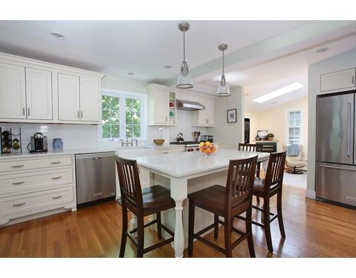 60 Arapahoe Road Newton, MA 02465 - Photo 2 of 13 a kitchen with stainless steel appliances kitchen island granite countertop a table chairs and a refrigerator