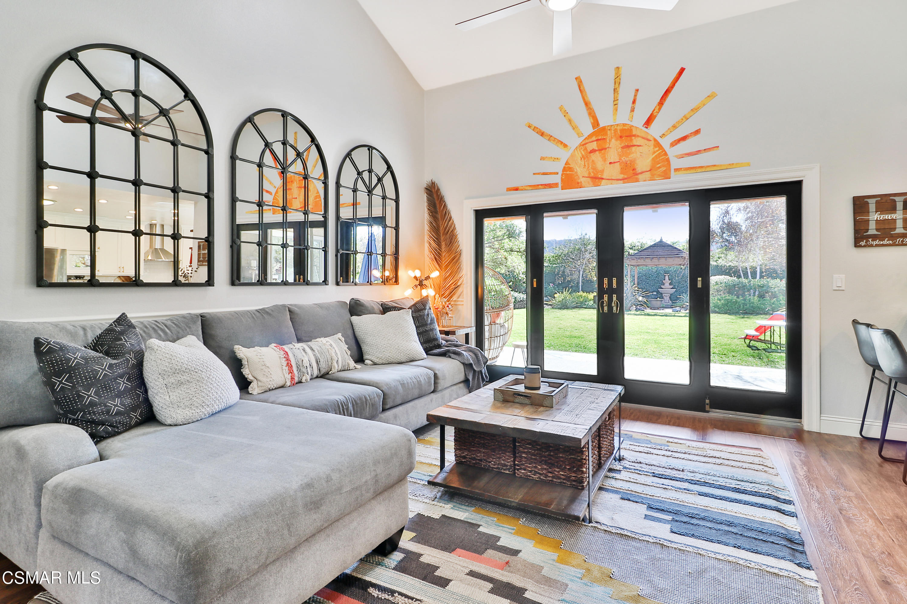 5938 Serena Street Simi Valley, CA 93063 - Photo 39 of 76 a living room with furniture a fireplace and a floor to ceiling window