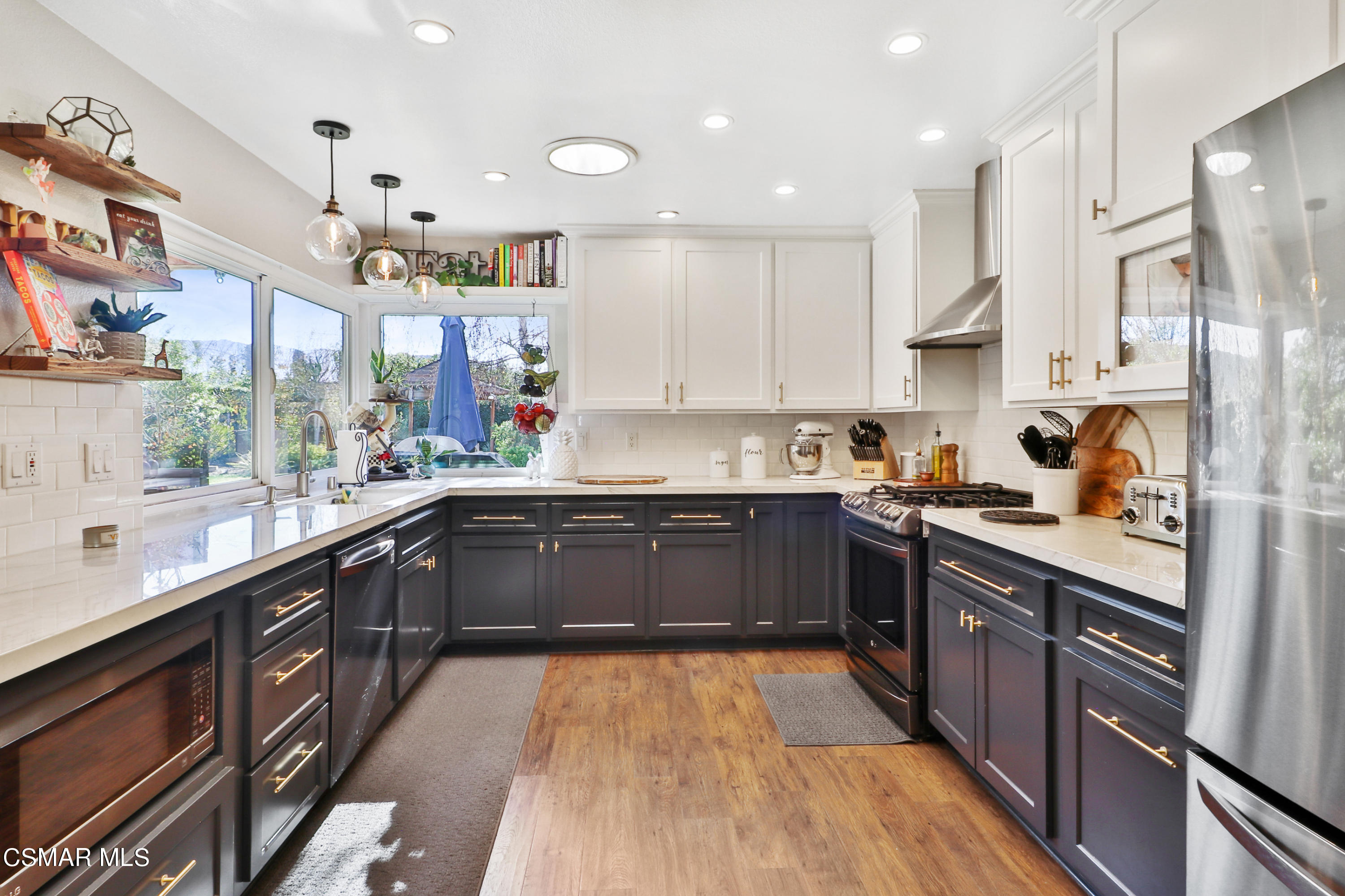 5938 Serena Street Simi Valley, CA 93063 - Photo 44 of 76 a kitchen with stainless steel appliances granite countertop a sink and cabinets