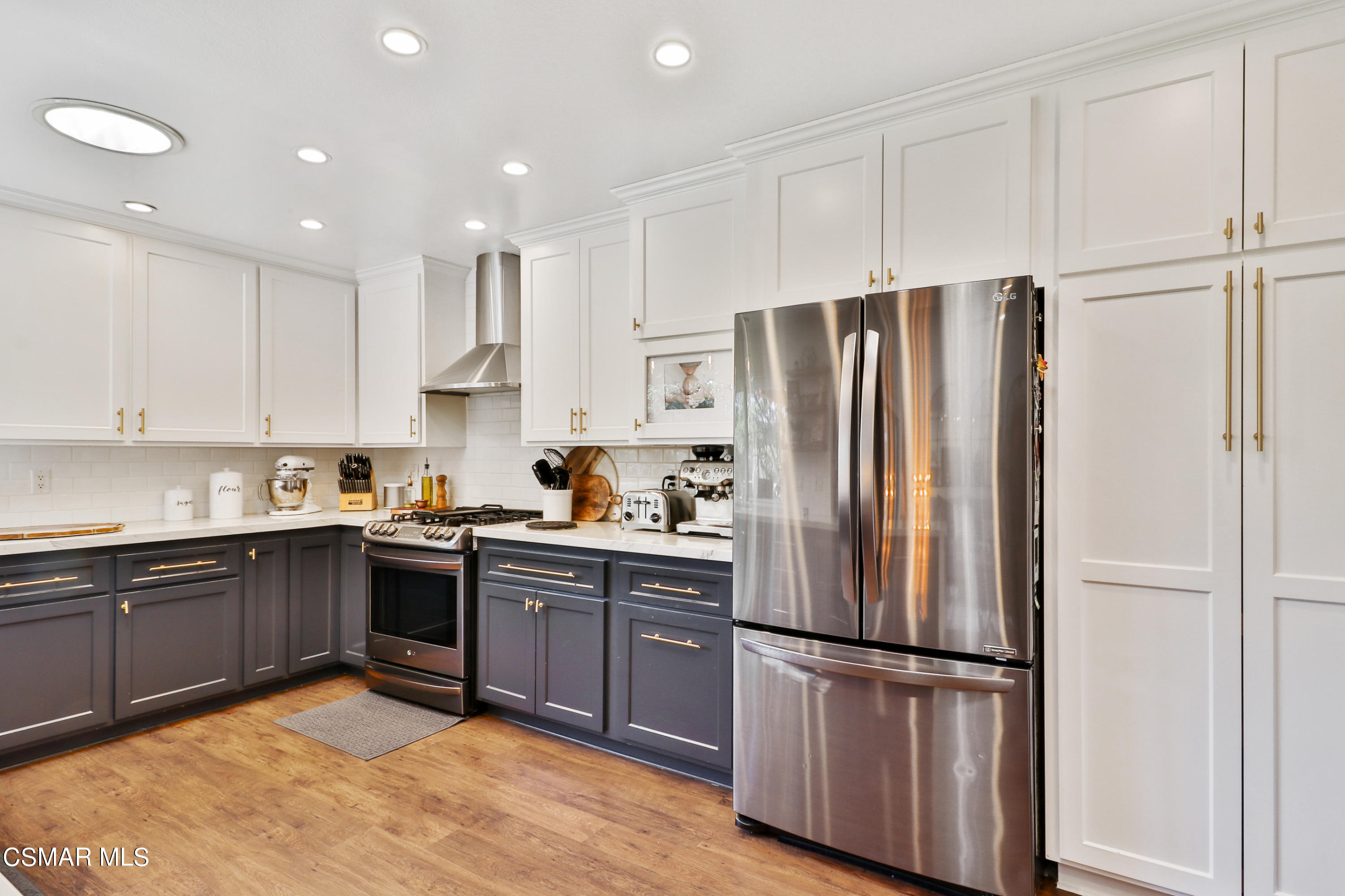 5938 Serena Street Simi Valley, CA 93063 - Photo 47 of 76 a kitchen with stainless steel appliances granite countertop a refrigerator sink and cabinets