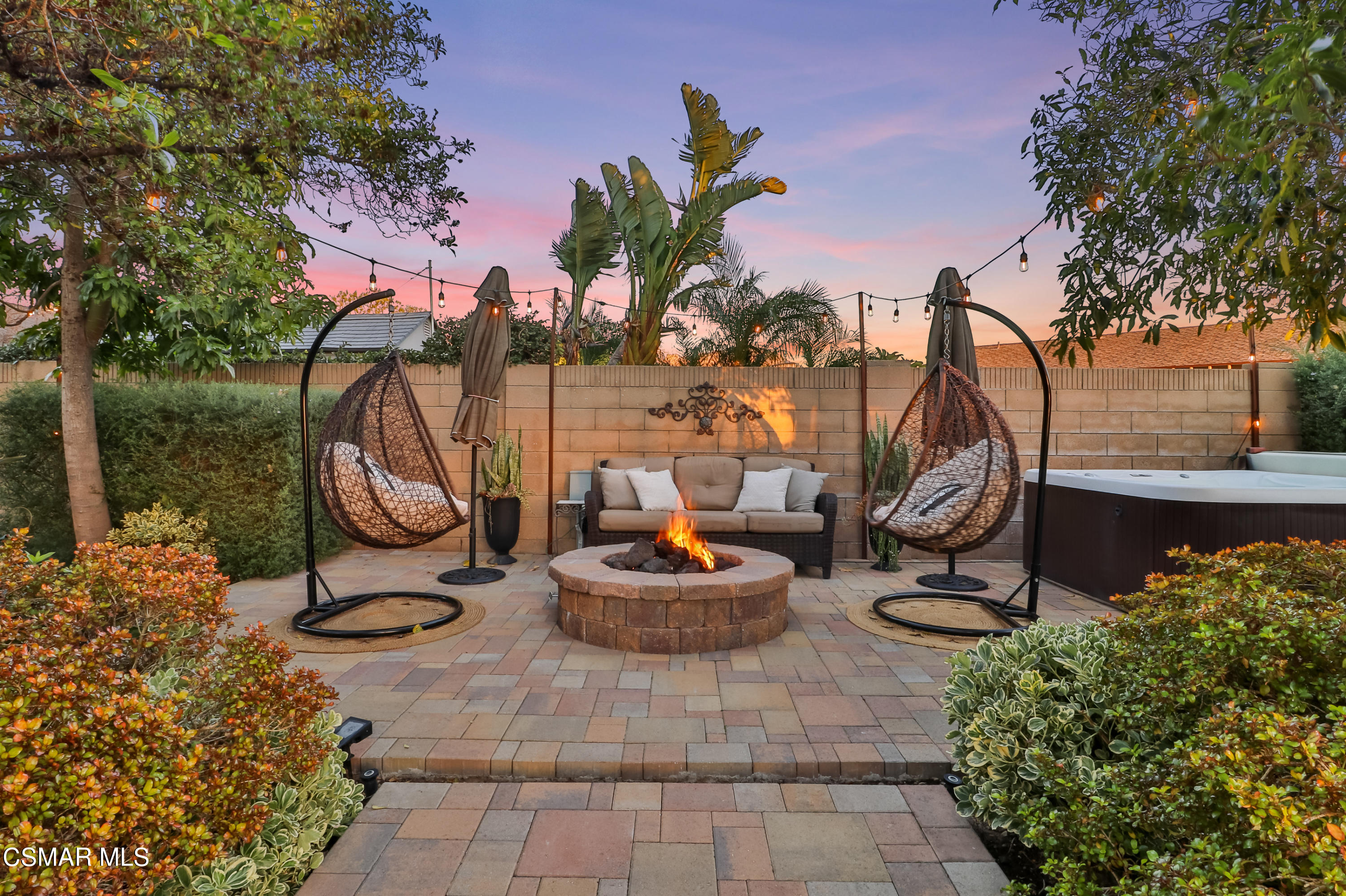 5938 Serena Street Simi Valley, CA 93063 - Photo 64 of 76 a backyard of a house with fountain table and chairs potted plants