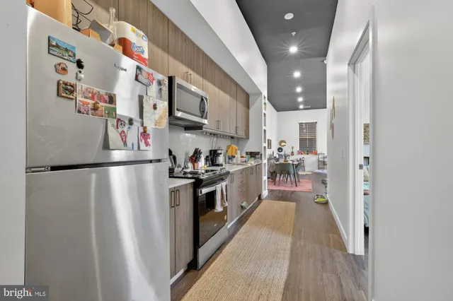 a kitchen with stainless steel appliances granite countertop a refrigerator and a sink