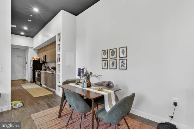 a living room with furniture a rug and a flat screen tv