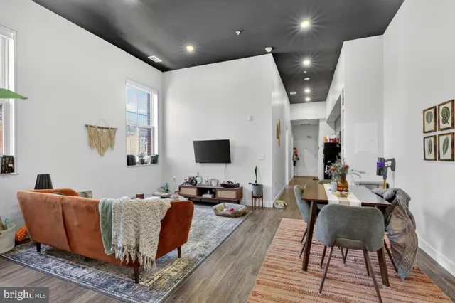 a bedroom with bed and a flat screen tv