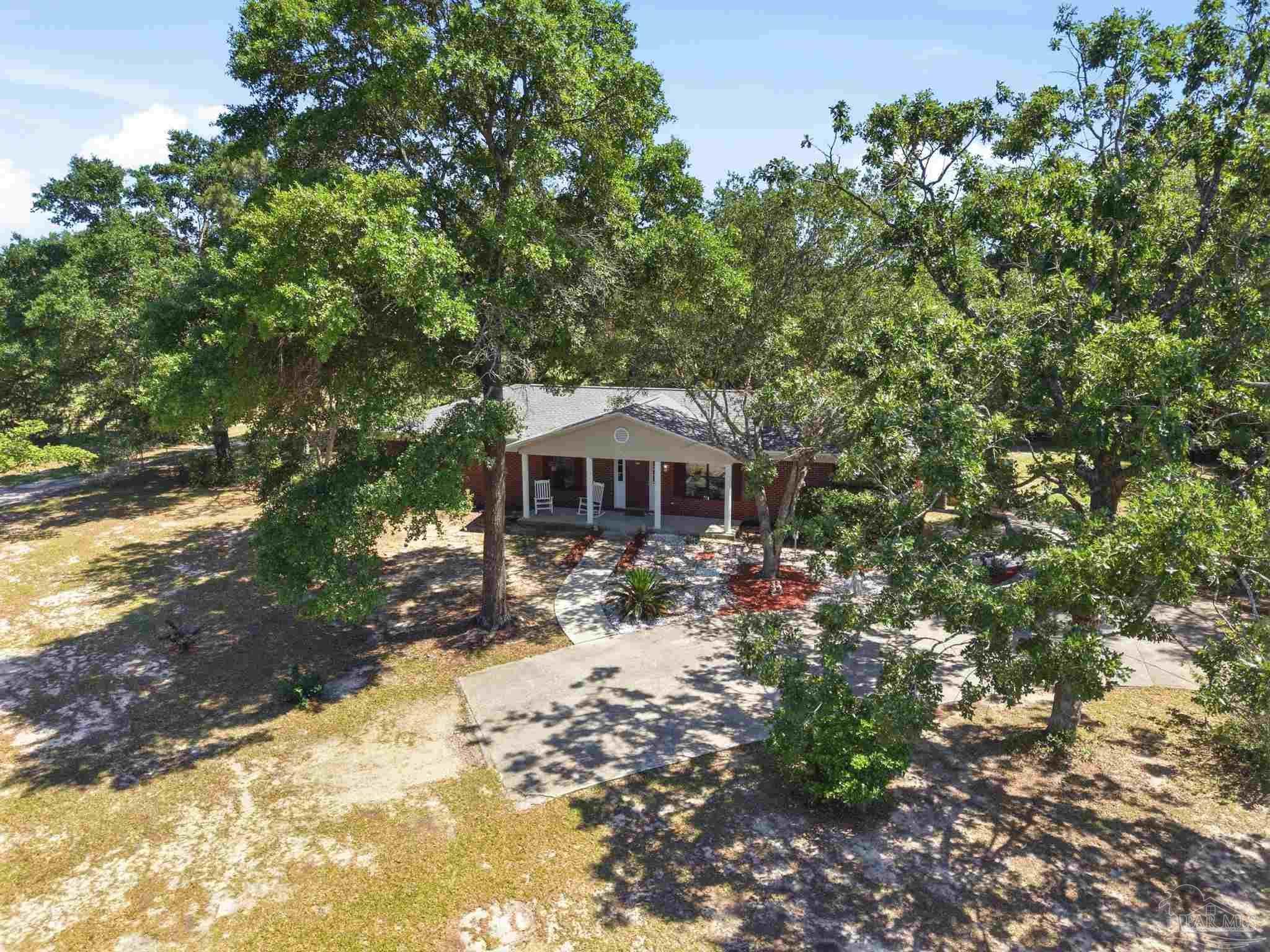 5121 Keyser Mill Road Baker, FL 32531 - Photo 35 of 52 a view of a house with a yard