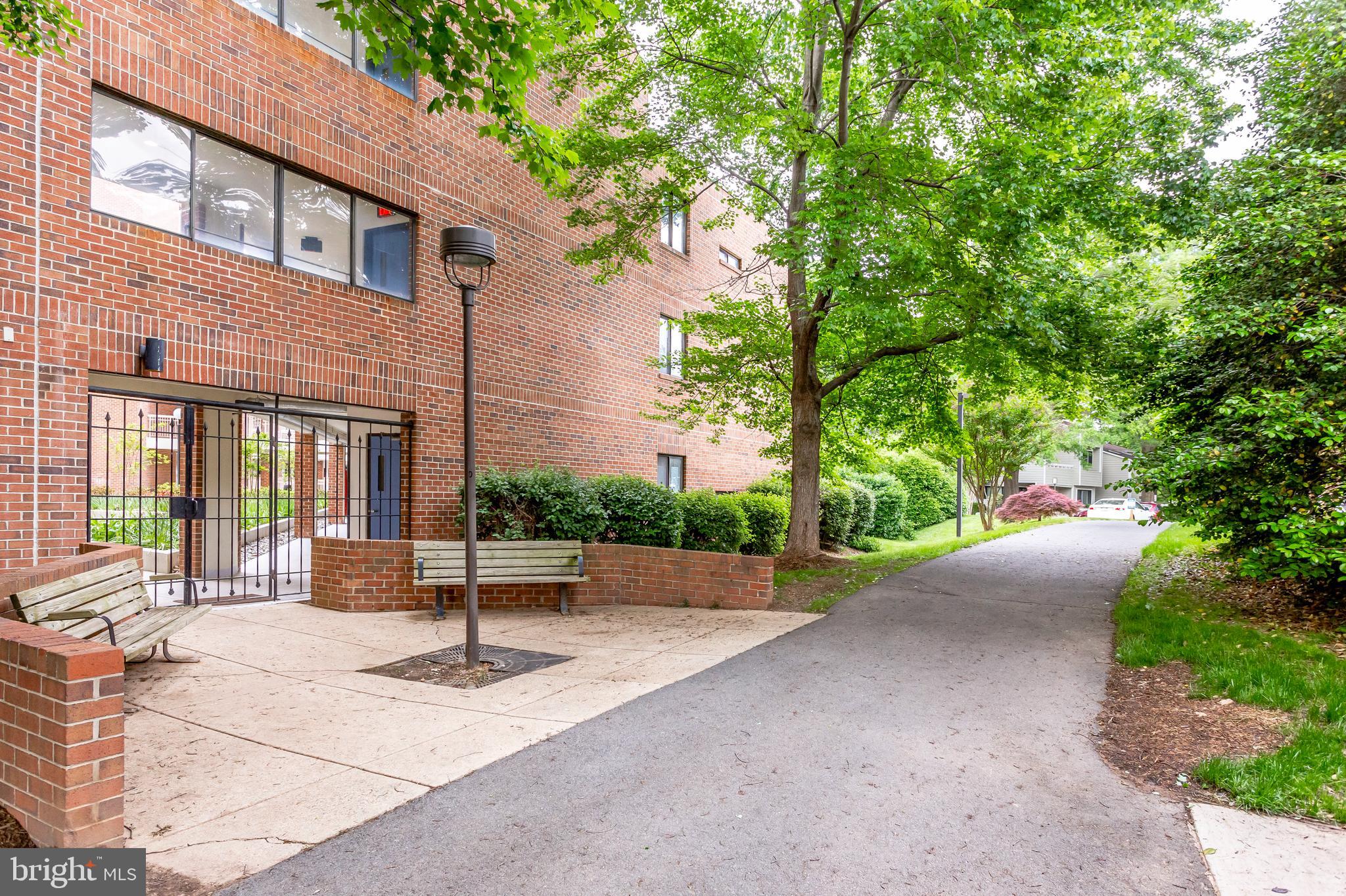 1951 Sagewood Lane, Unit 517 Reston, VA 20191 - Photo 4 of 50 A view of the side of the building and benches.