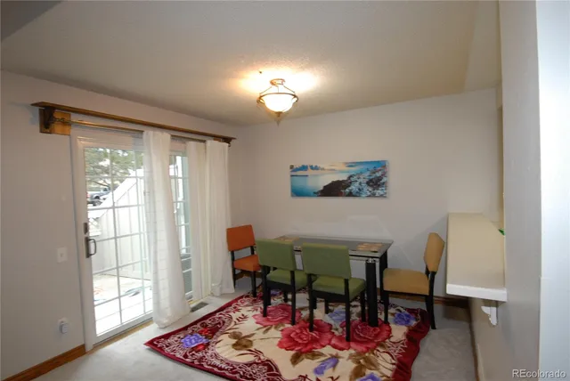 a view of a dining room with furniture and a window