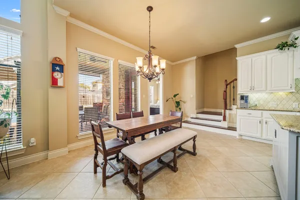 a living room with patio furniture and a potted plants