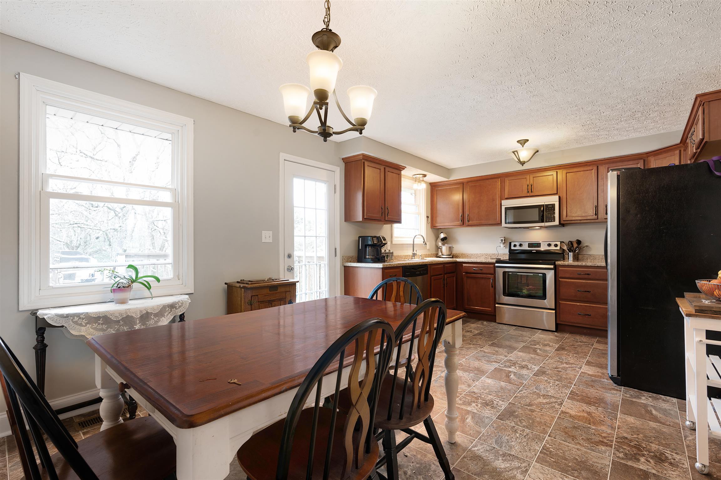 1578 Hickory Point Road Clarksville, TN 37043 - Photo 4 of 17 a view of a dining room with furniture a chandelier and kitchen view