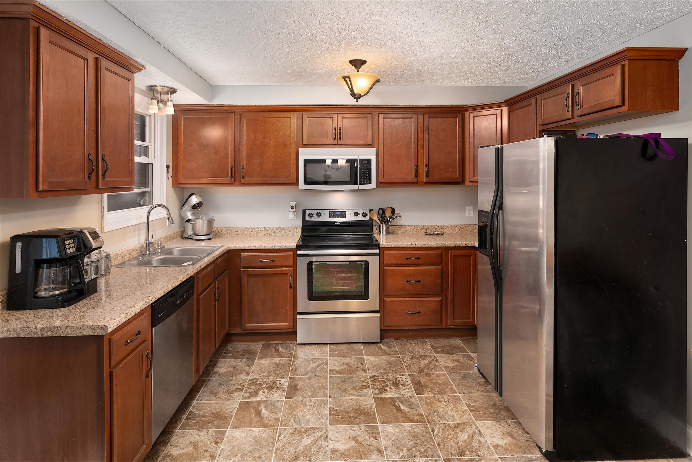 1578 Hickory Point Road Clarksville, TN 37043 - Photo 6 of 17 a kitchen with stainless steel appliances granite countertop a refrigerator stove and sink
