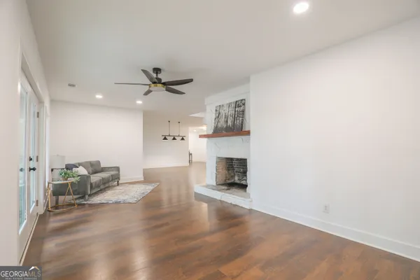 a bed sitting in a spacious bedroom next to a window