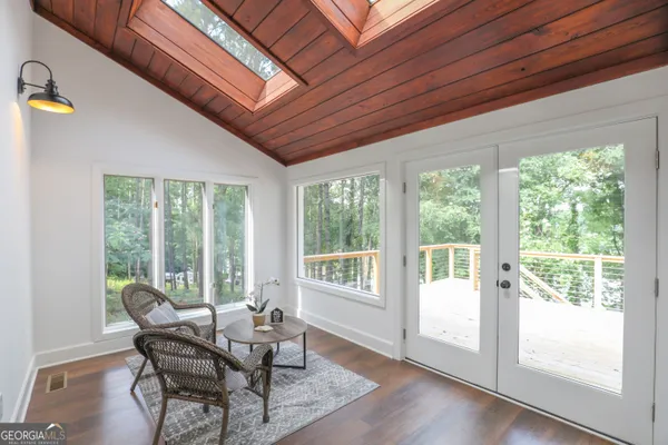a view of a dining room with furniture and wooden floor