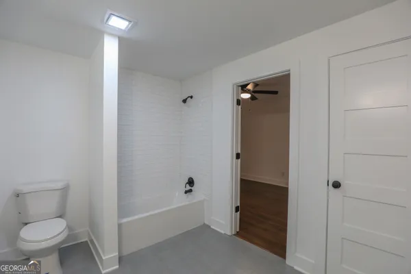 a view of a room with wooden floor and windows
