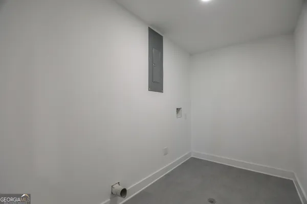 a view of a room with wooden floor stairs and a view of kitchen