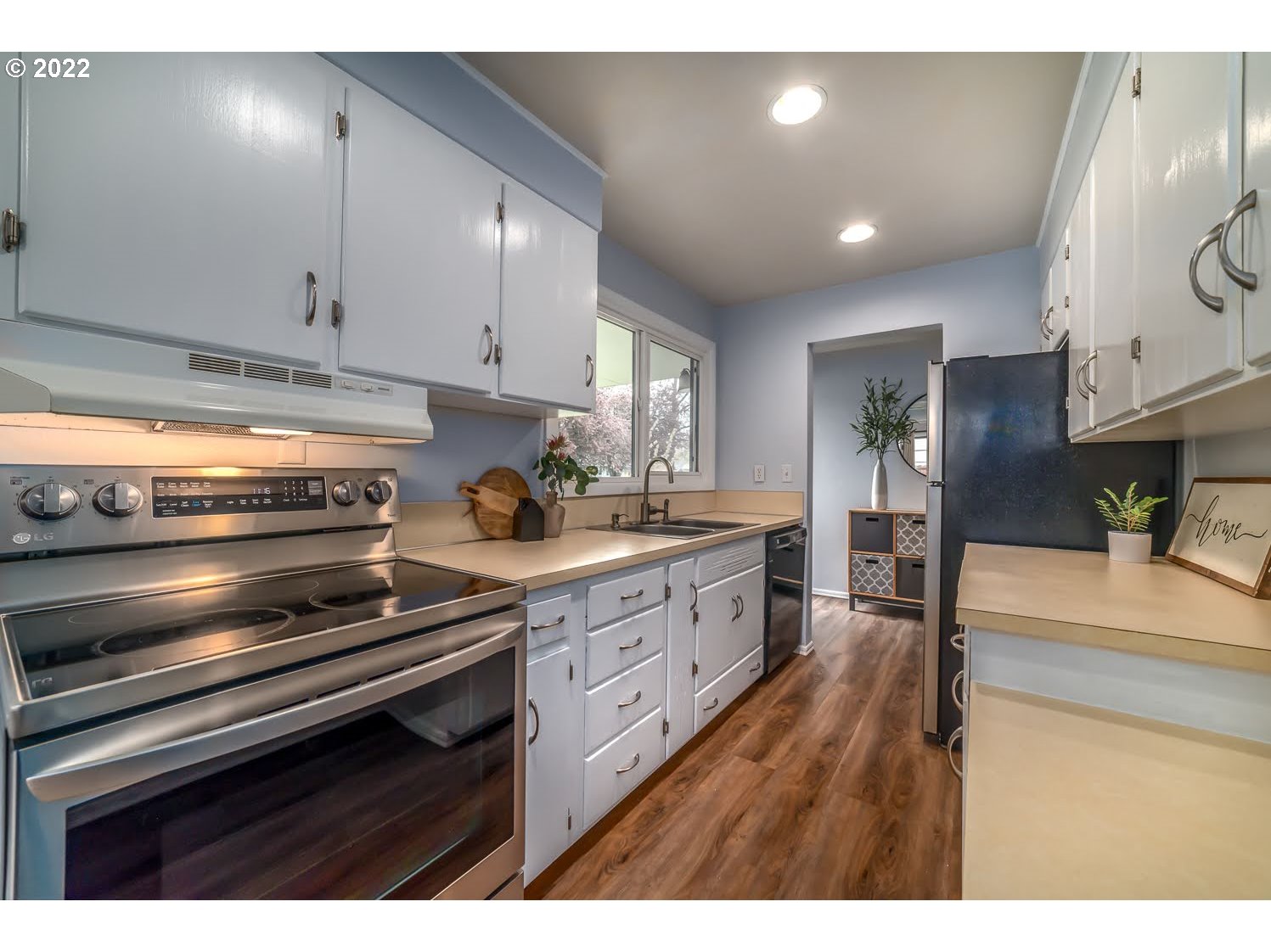 1453 Olympic Street Springfield, OR 97477 - Photo 13 of 31 a kitchen with sink cabinets and stove top oven