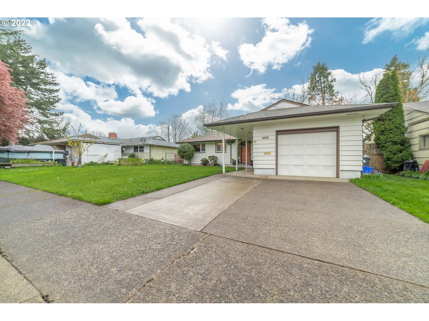1453 Olympic Street Springfield, OR 97477 - Photo 2 of 31 a view of a house with a yard and garage
