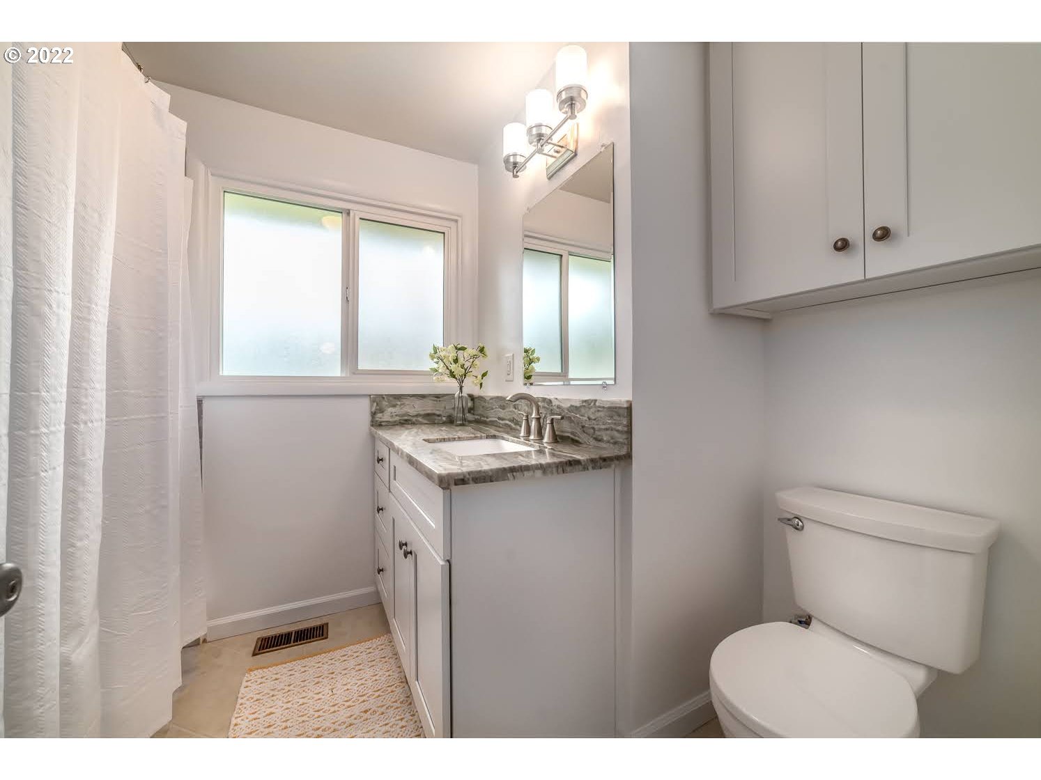 1453 Olympic Street Springfield, OR 97477 - Photo 21 of 31 a bathroom with a toilet a sink a vanity and mirror