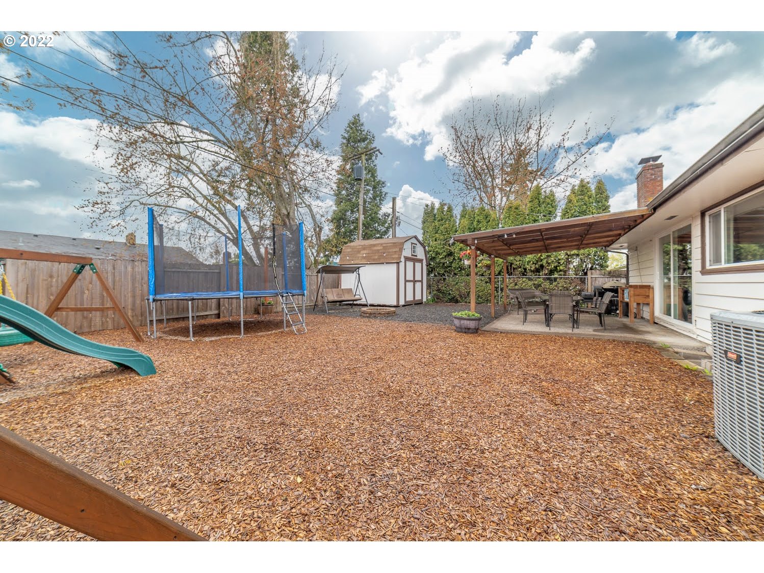 1453 Olympic Street Springfield, OR 97477 - Photo 29 of 31 a backyard of a house with barbeque oven table and chairs