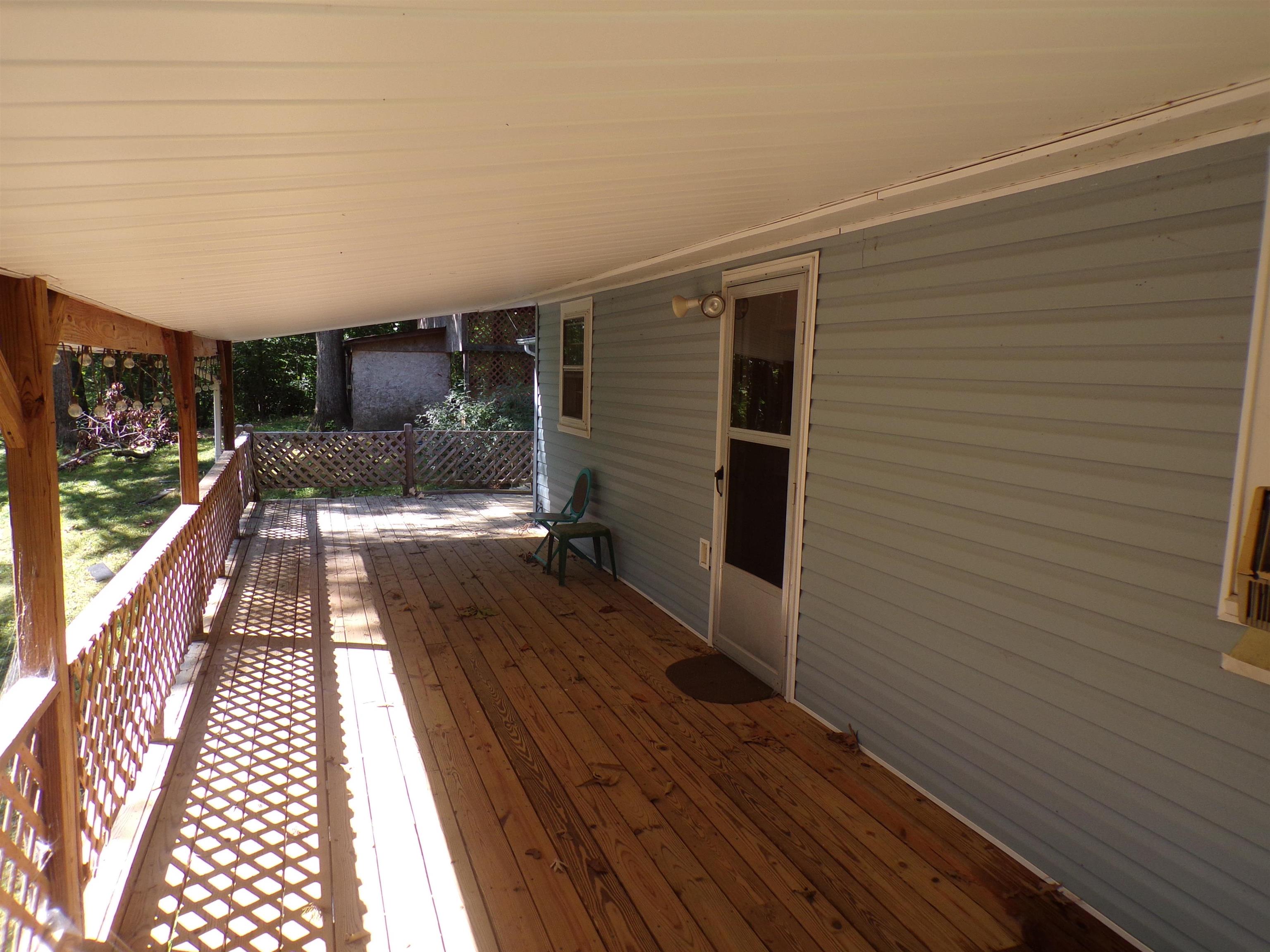 35 Cr 341 Road Iuka, MS 38852 - Photo 12 of 15 Covered outdoor deck featuring wood-finish flooring and lattice railing