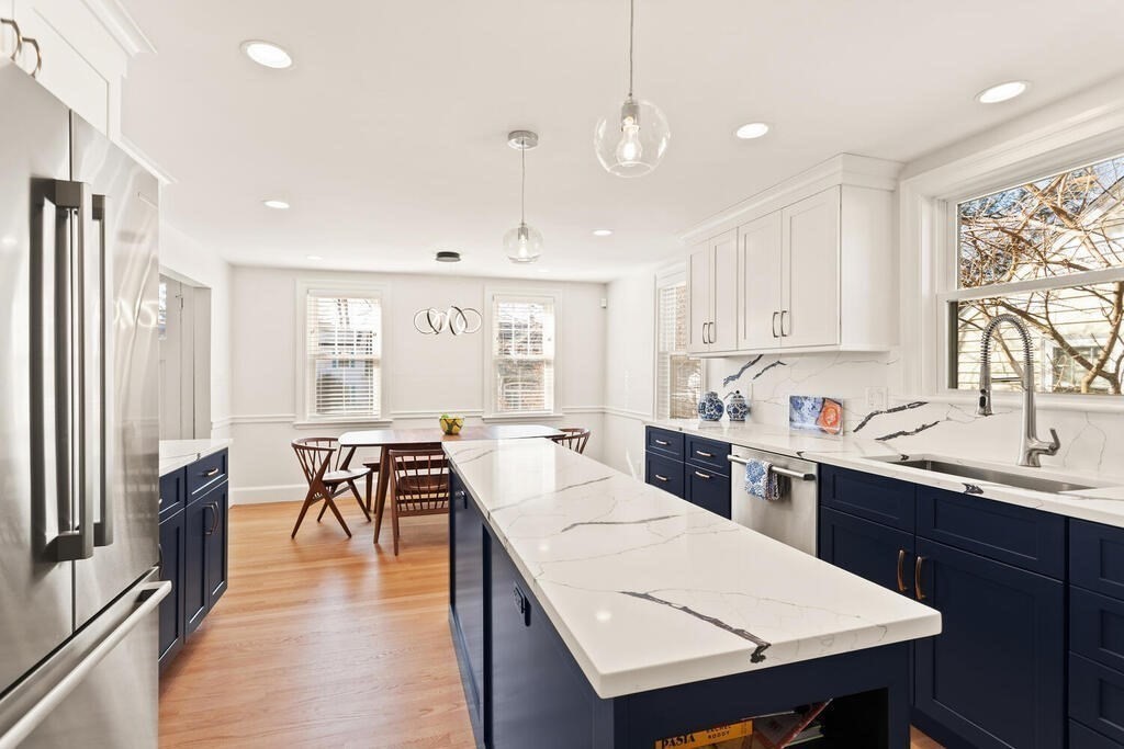 55 Harding Road Lexington, MA 02420 - Photo 7 of 18 a large kitchen with kitchen island a dining table and chairs