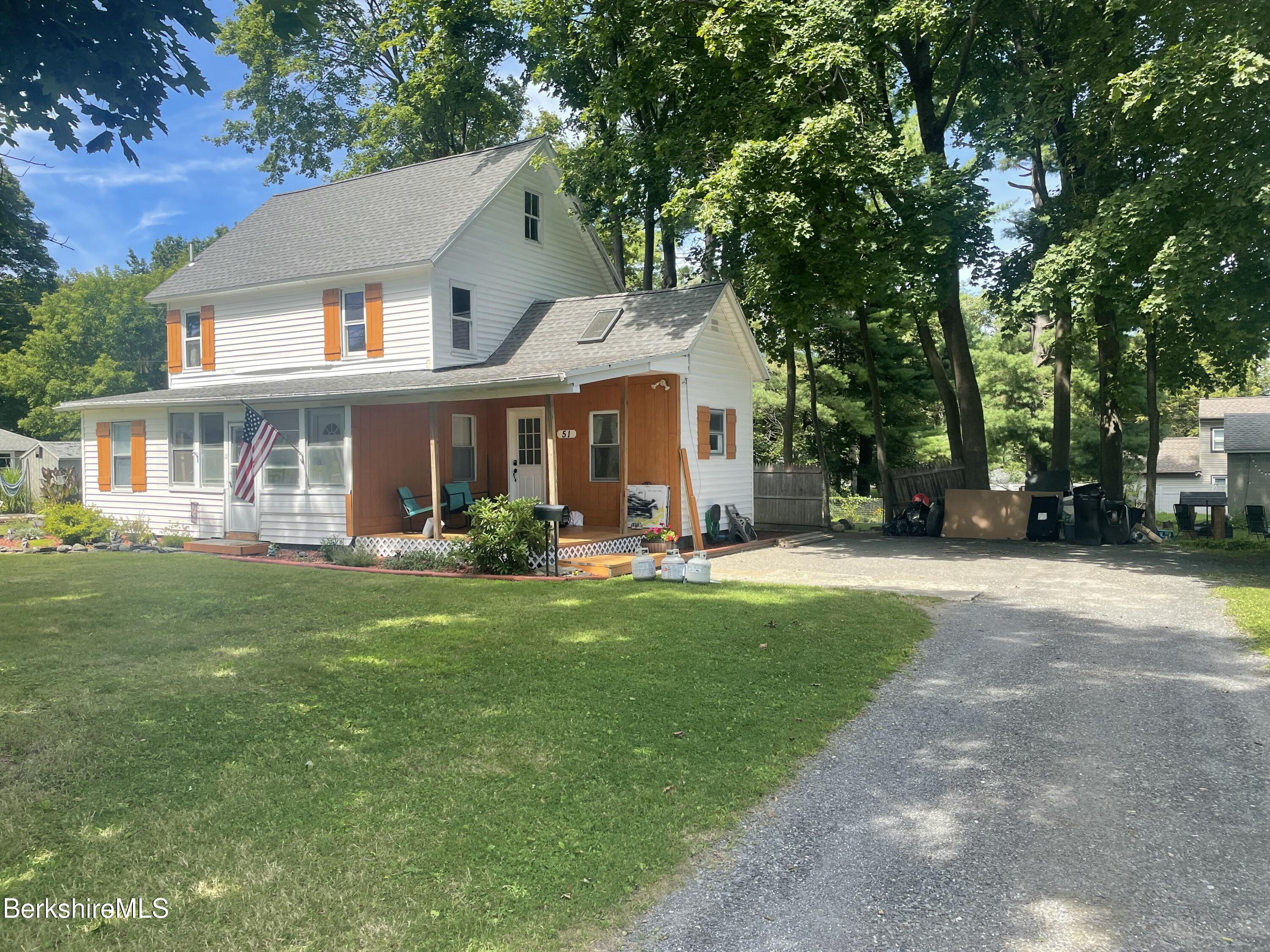 51 Foote Avenue Pittsfield, MA 01201 - Photo 2 of 16 a front view of a house with a garden and trees