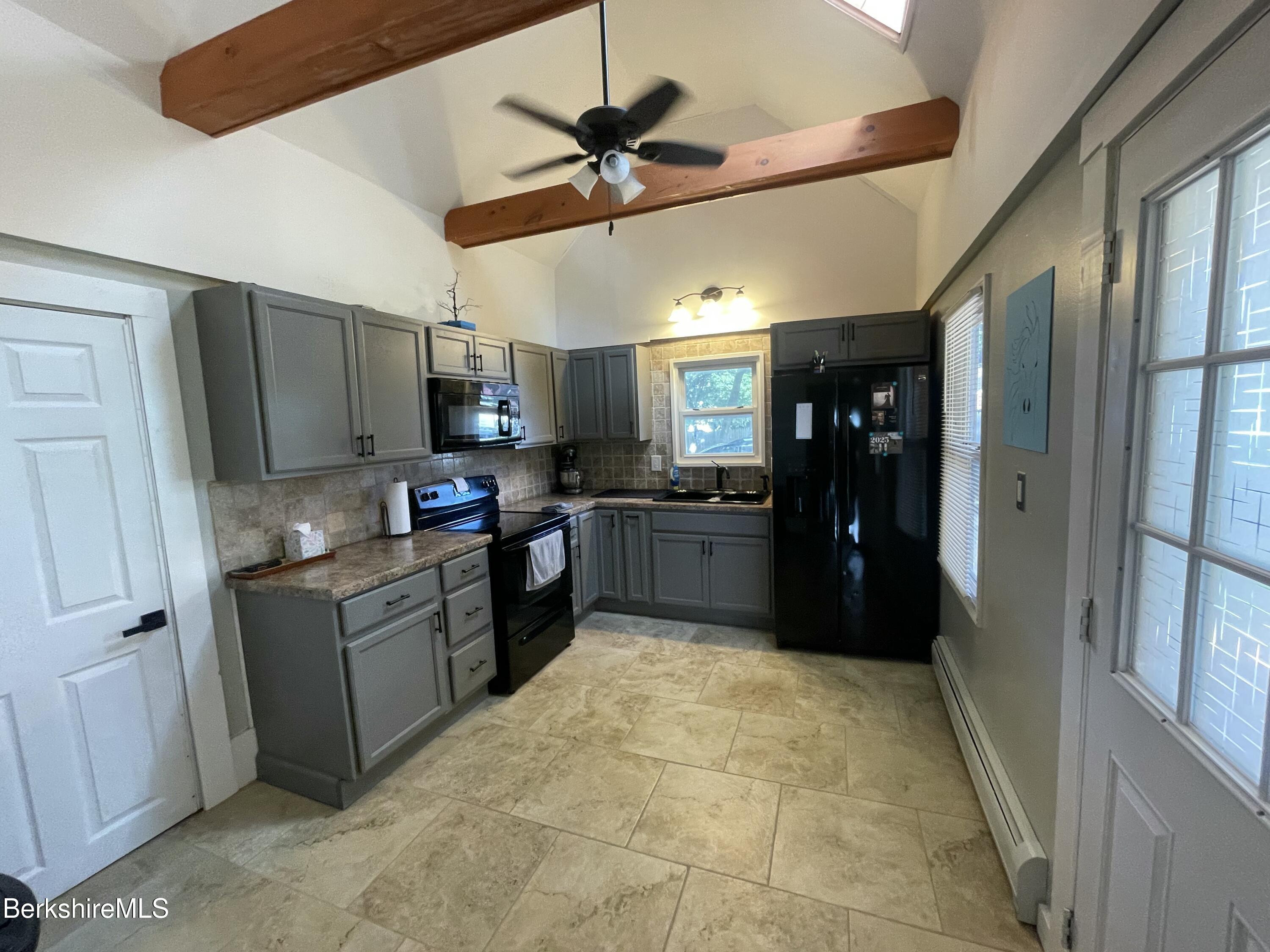 51 Foote Avenue Pittsfield, MA 01201 - Photo 8 of 16 a large kitchen with cabinets and stainless steel appliances