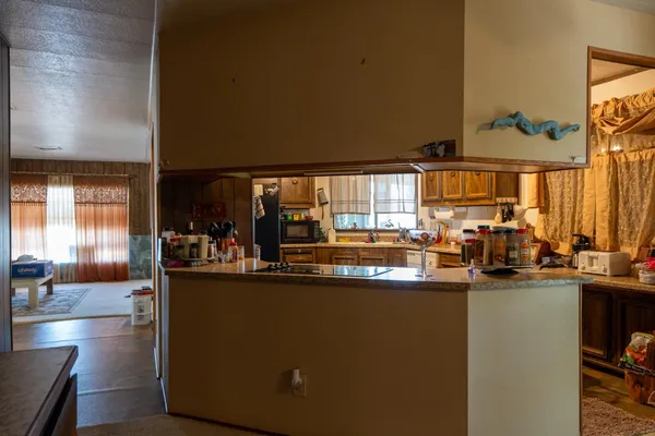 a kitchen with counter top space and living room