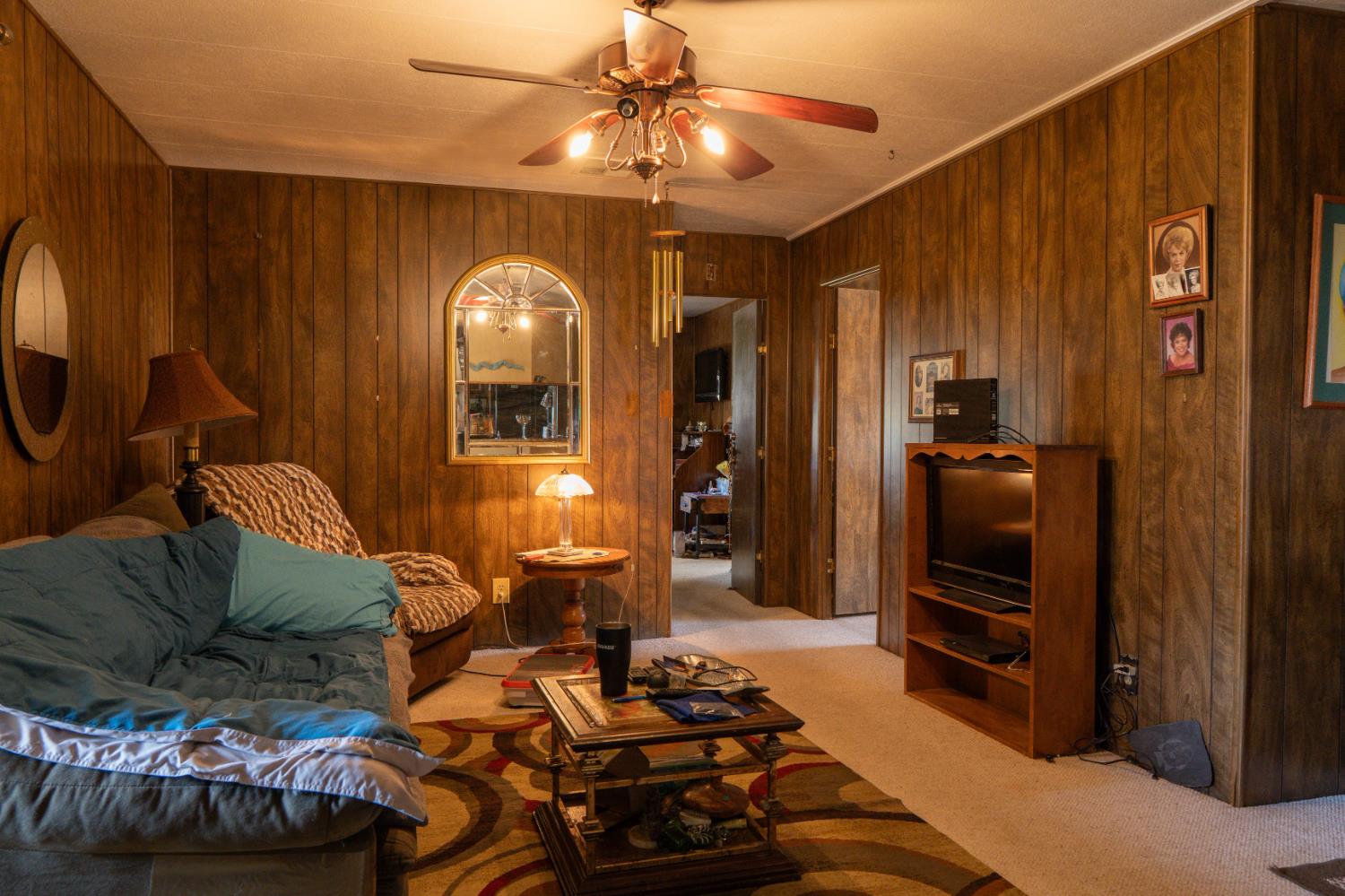2500 North State Highway, Unit 36 Merced, CA 95348 - Photo 18 of 50 a living room with furniture and a chandelier
