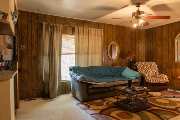 a bed sitting in a room next to a window
