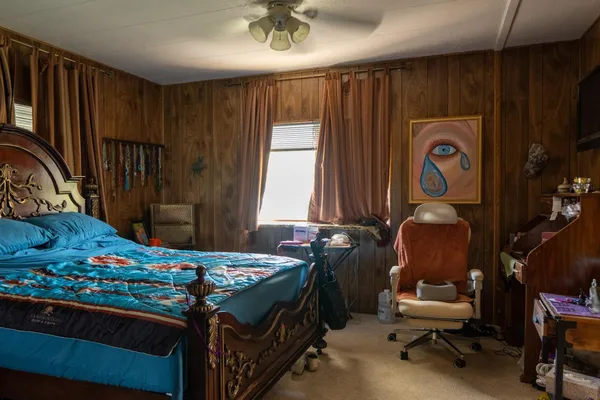 a bedroom with a bed and a window