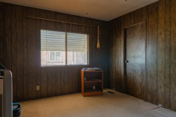 a room with a window and dresser