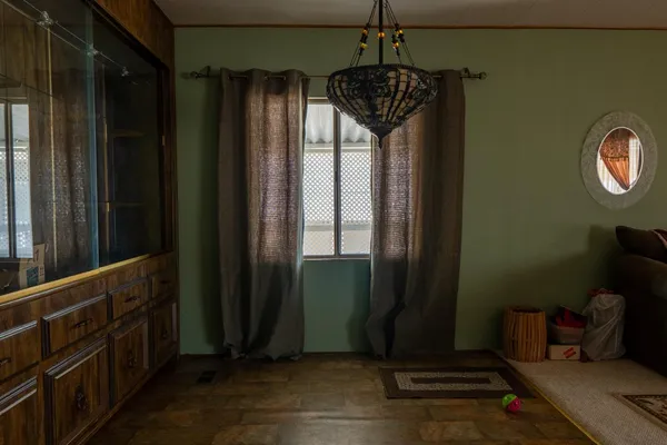 a view of a hallway with wooden floor and stairs