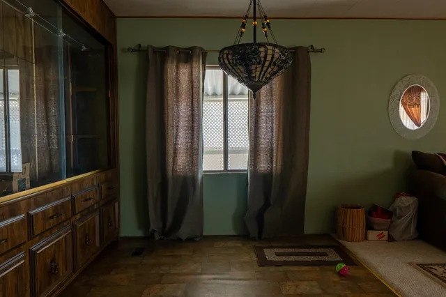 a view of a hallway with wooden floor and stairs
