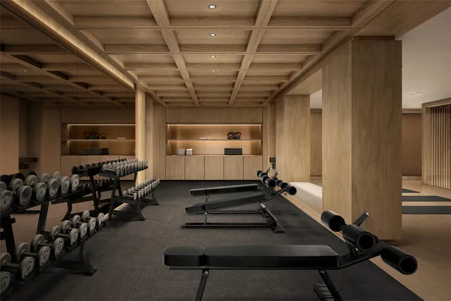 a room with gym equipment and mirrors