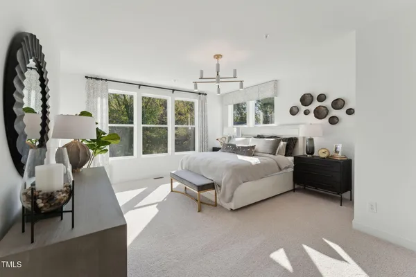 a spacious bedroom with a bed and window