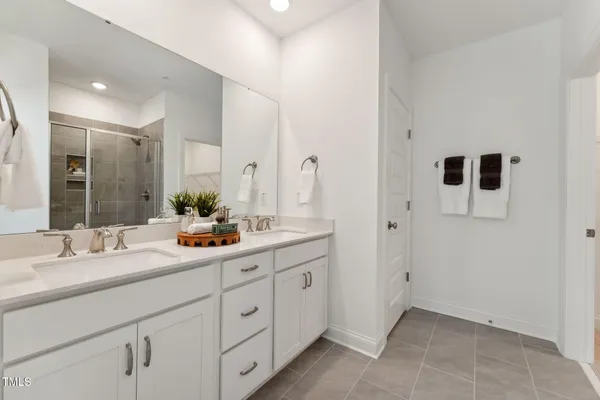 a bathroom with a double vanity sink and mirror