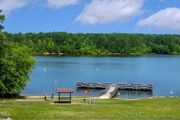 an aerial view of a house with a yard and lake view