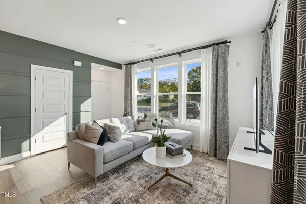 a living room with furniture and a large window