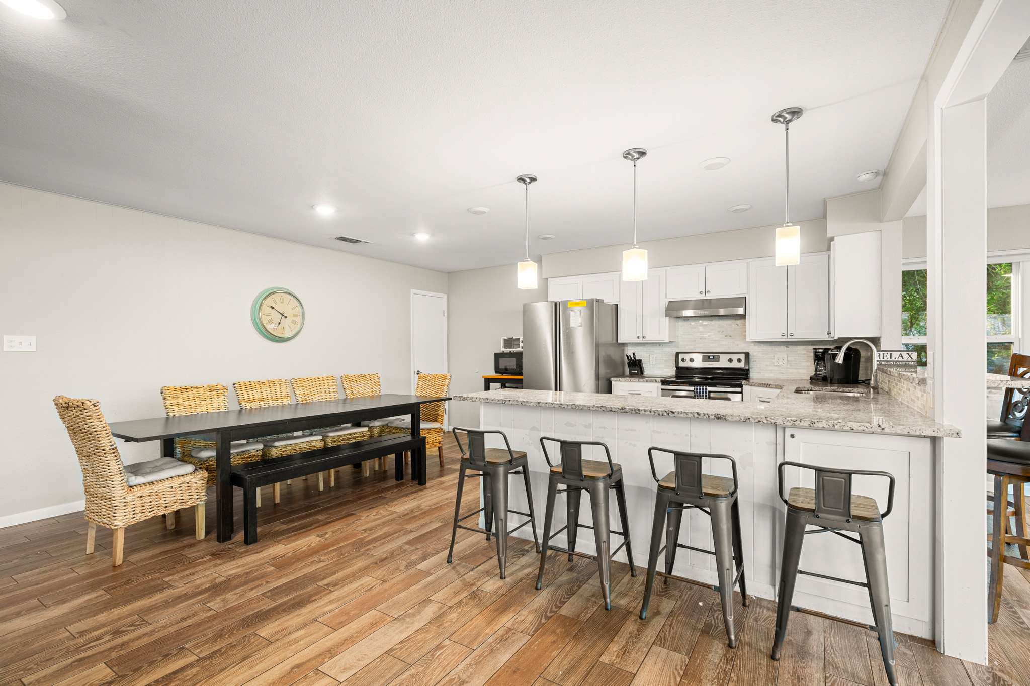 508 Riverside Drive Kingsland, TX 78639 - Photo 12 of 39 a kitchen with stainless steel appliances a dining table chairs stove and white cabinets