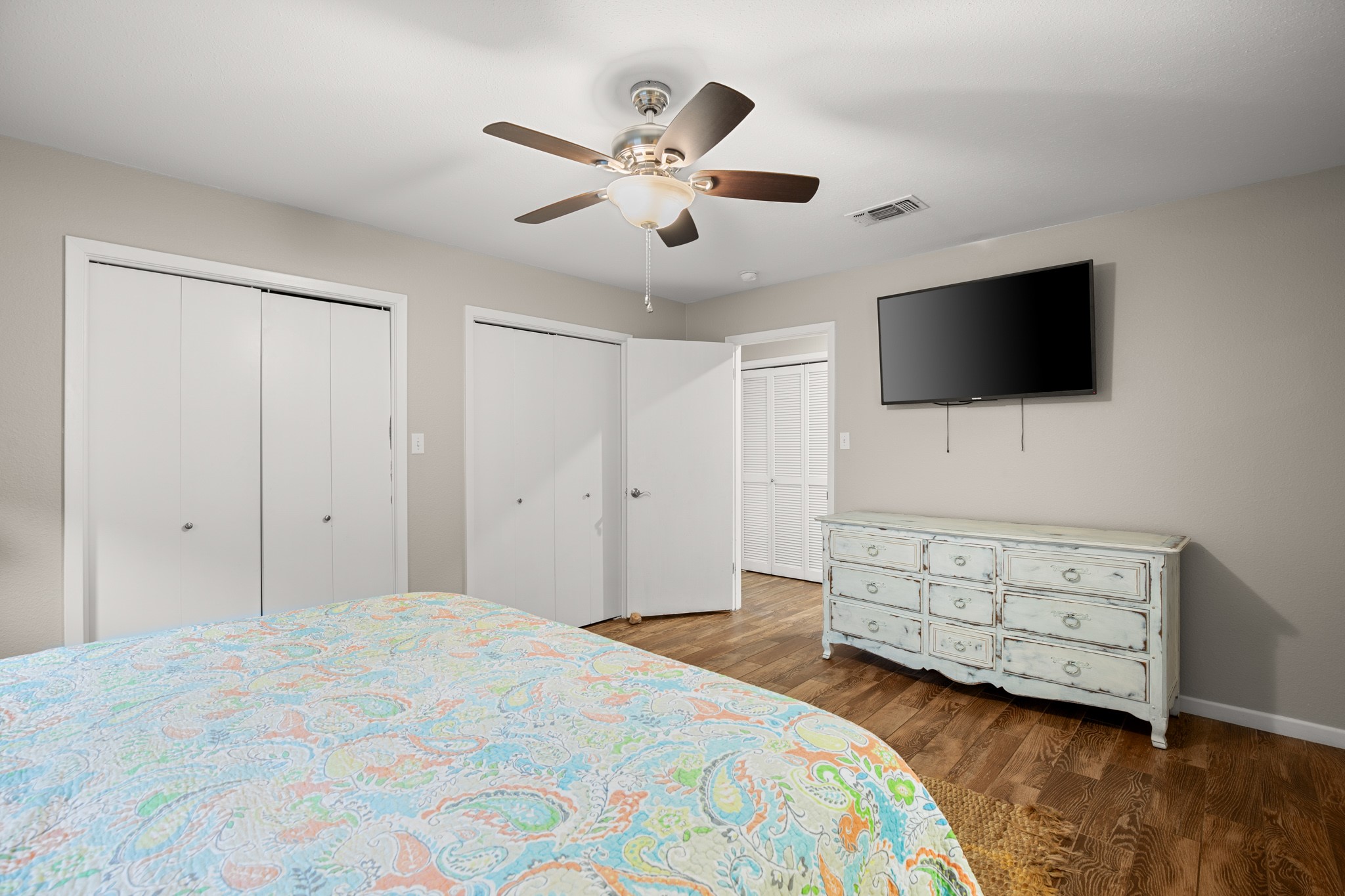 508 Riverside Drive Kingsland, TX 78639 - Photo 20 of 39 a bedroom with a bed a flat screen tv and a chandelier