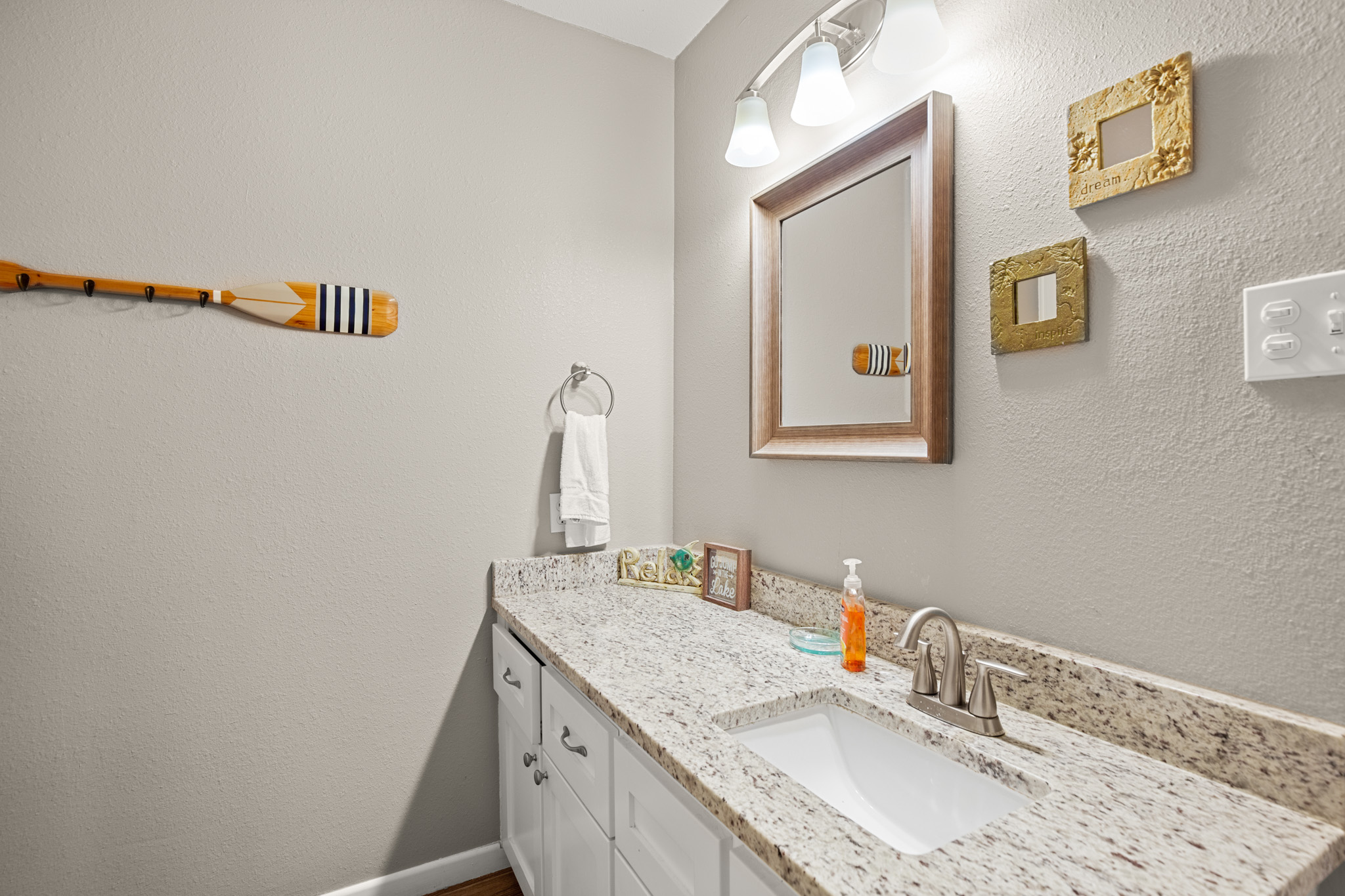 508 Riverside Drive Kingsland, TX 78639 - Photo 24 of 39 a bathroom with a granite countertop sink and a mirror