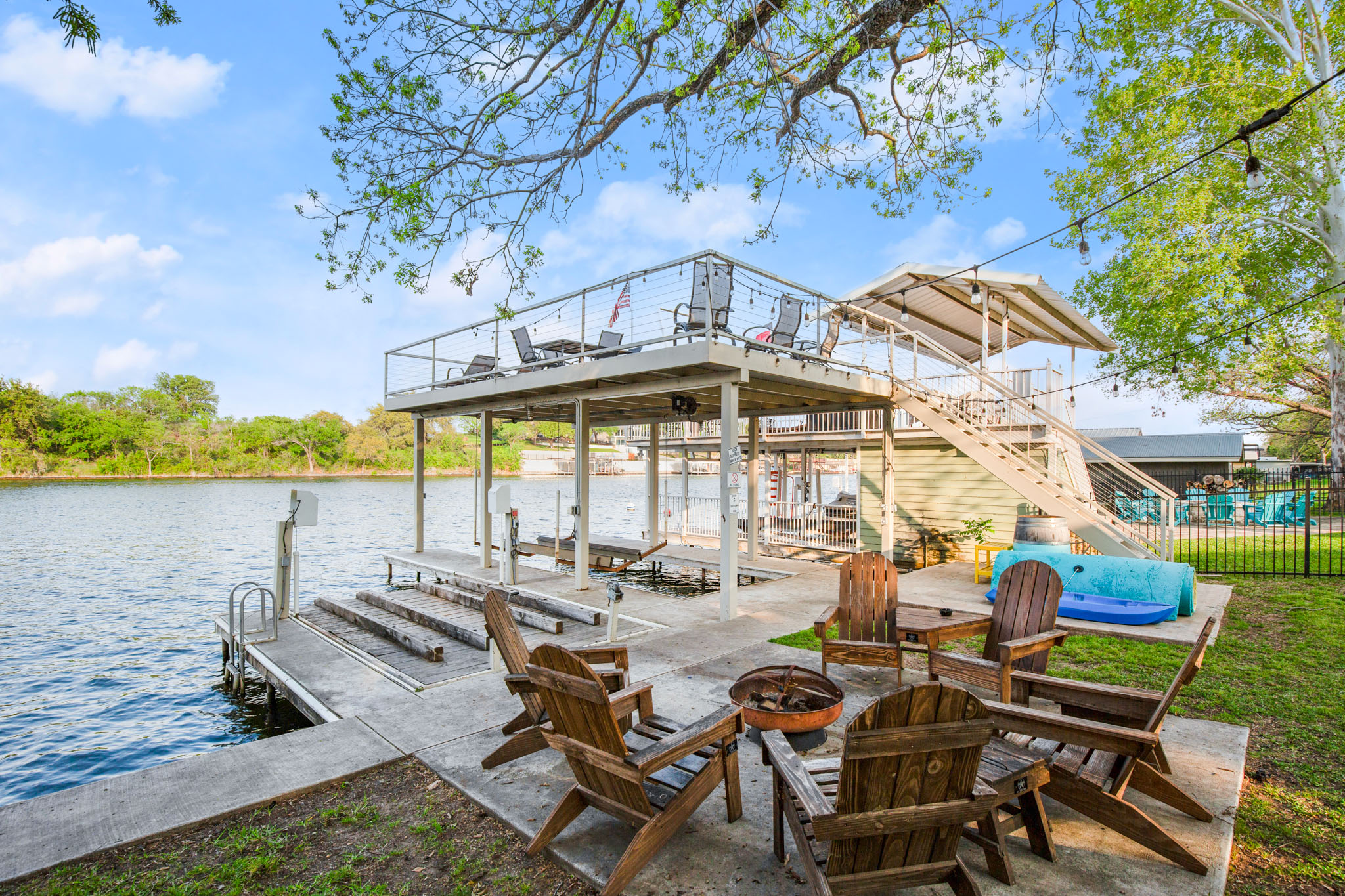 508 Riverside Drive Kingsland, TX 78639 - Photo 8 of 39 a view of a patio with lawn chairs under an umbrella