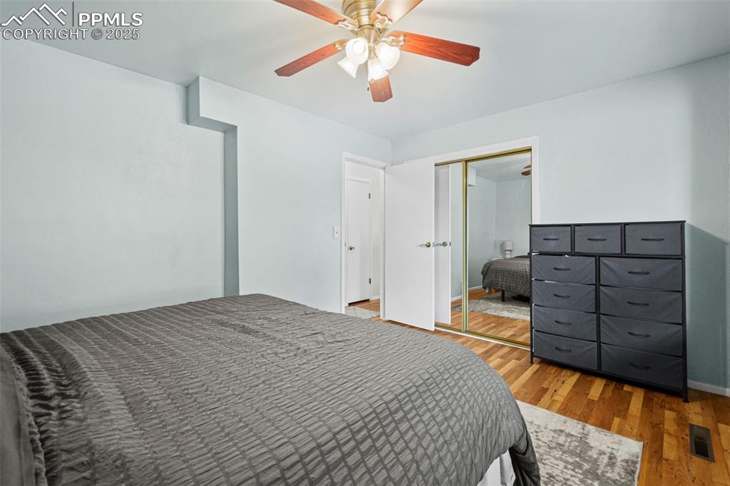3716 Indianpipe Circle Colorado Springs, CO 80918 - Photo 13 of 33 a bedroom with a bed and a chandelier